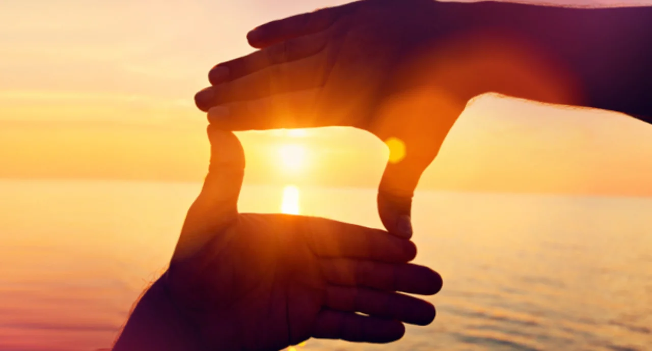 Giving a helping hand on the background of the dawn