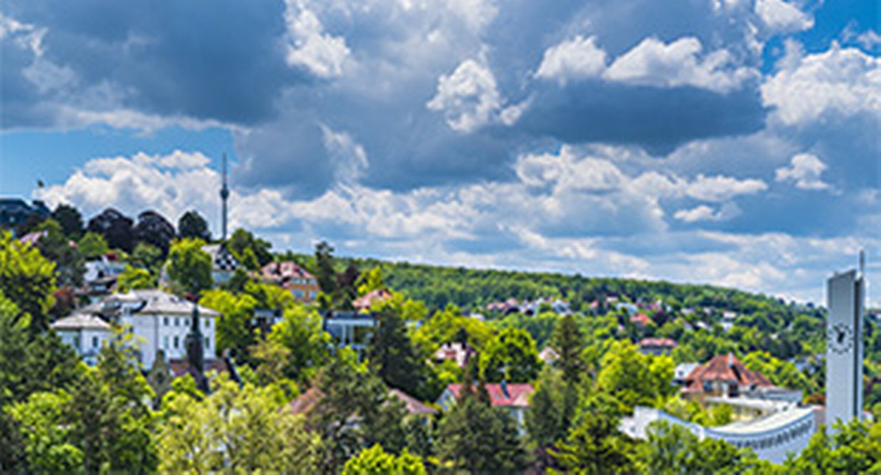 Scenic hillside with clouds, buildingsm and greenery