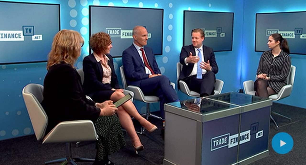 people discussing around a table in the Trade Finance TV