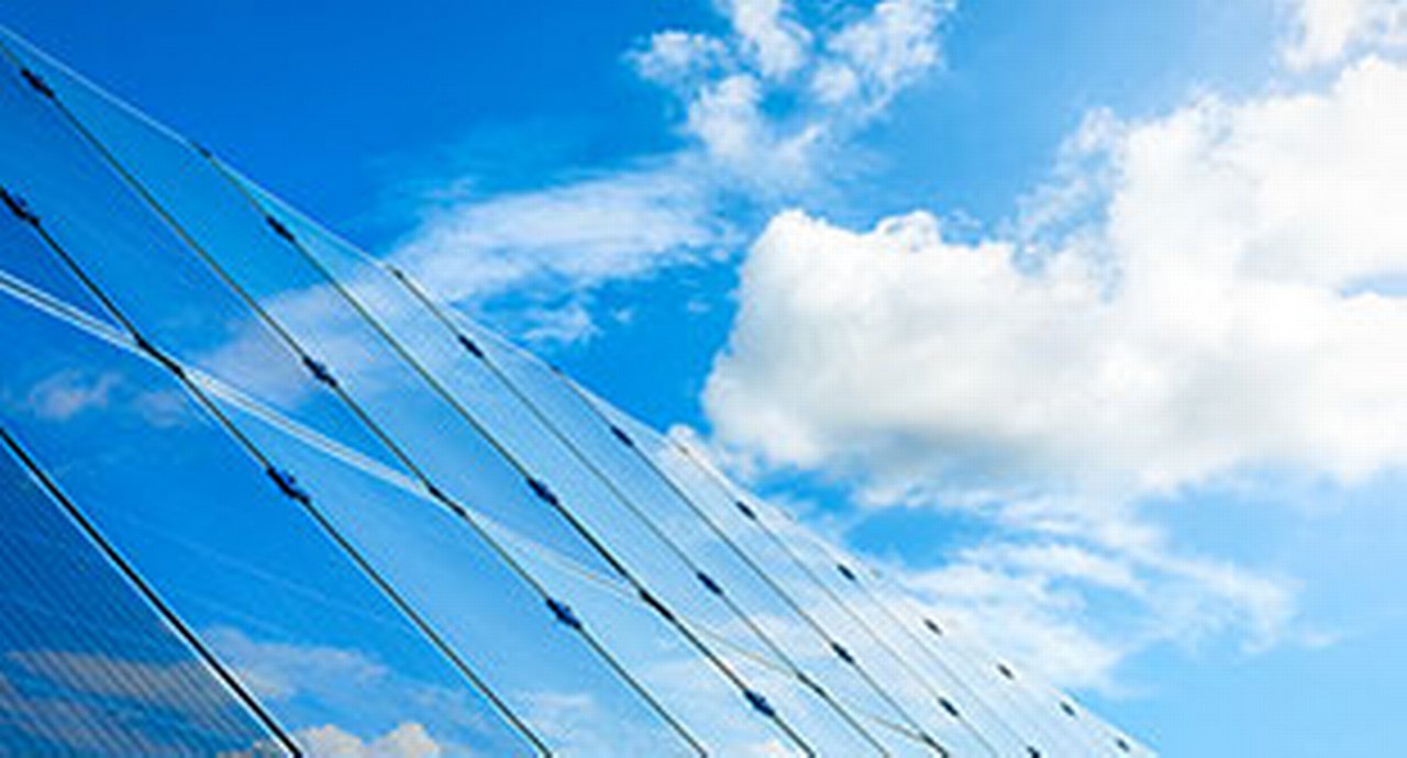 clouds reflected in a glazed skyscraper front