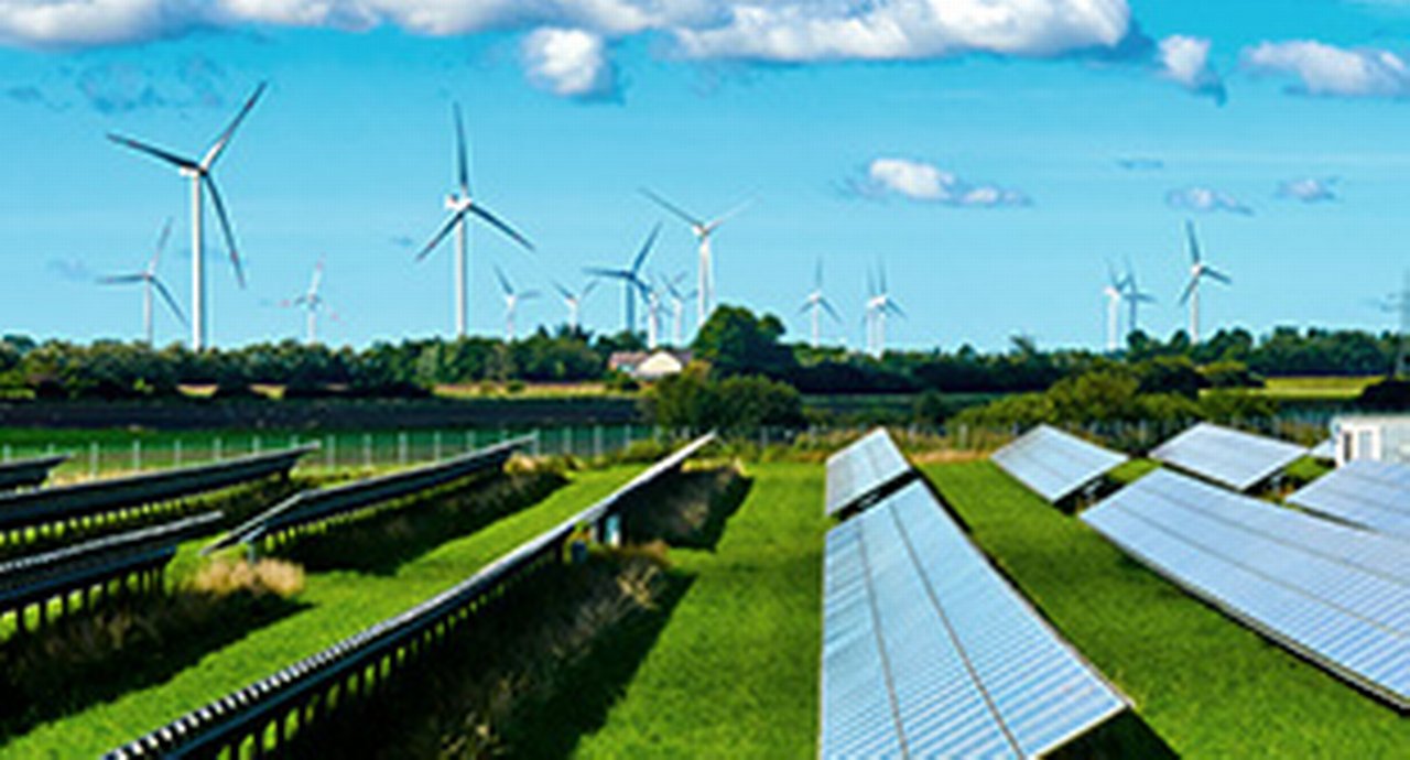 Solar panels and wind-powered generators on a green field