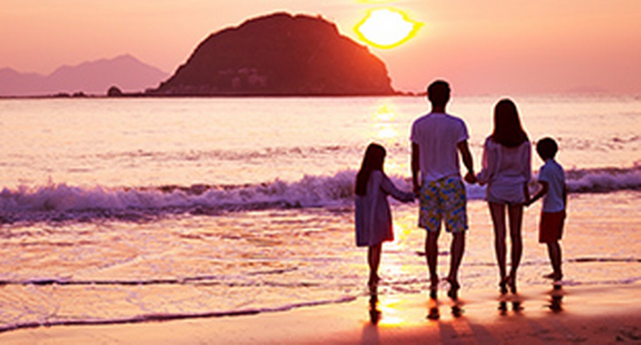 family at the beach on sunset