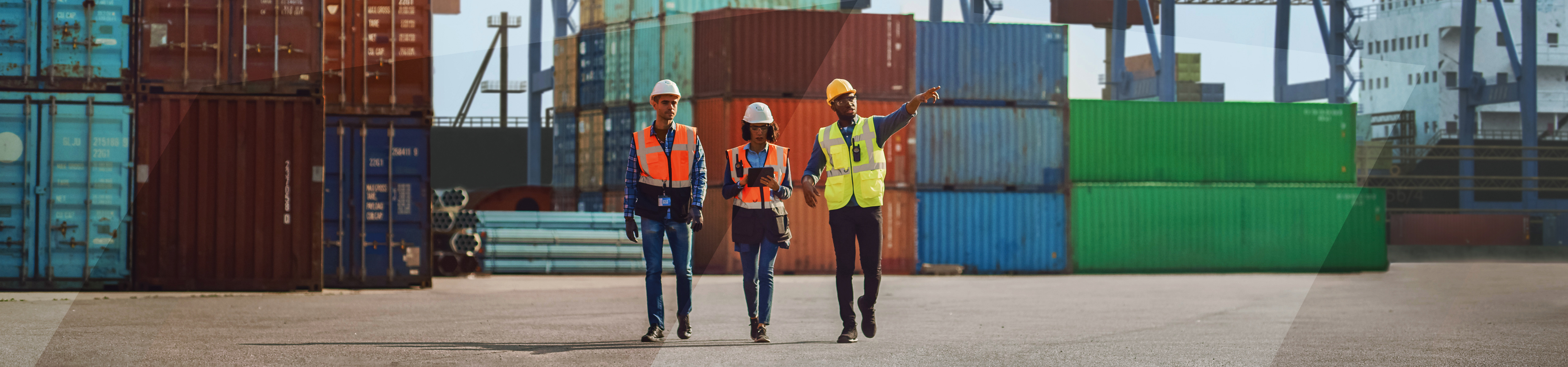 three workers inspect a container port