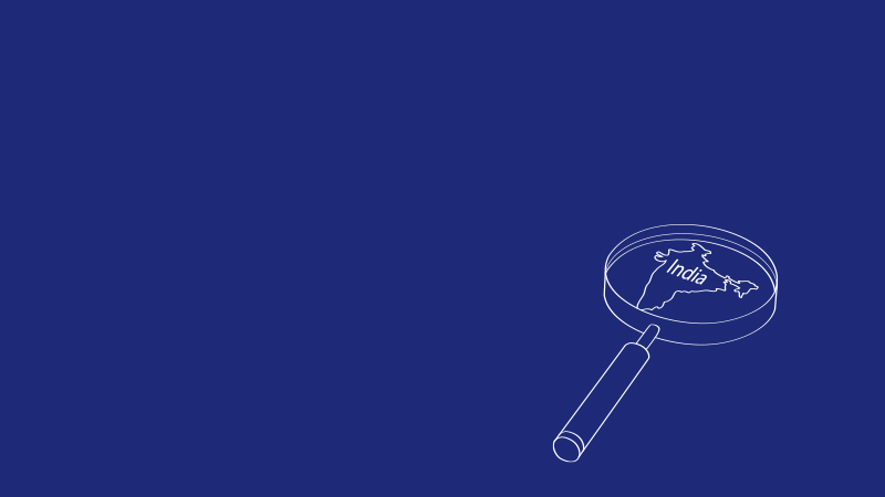 Vector image of a magnifying glass hovered over India on a blue background