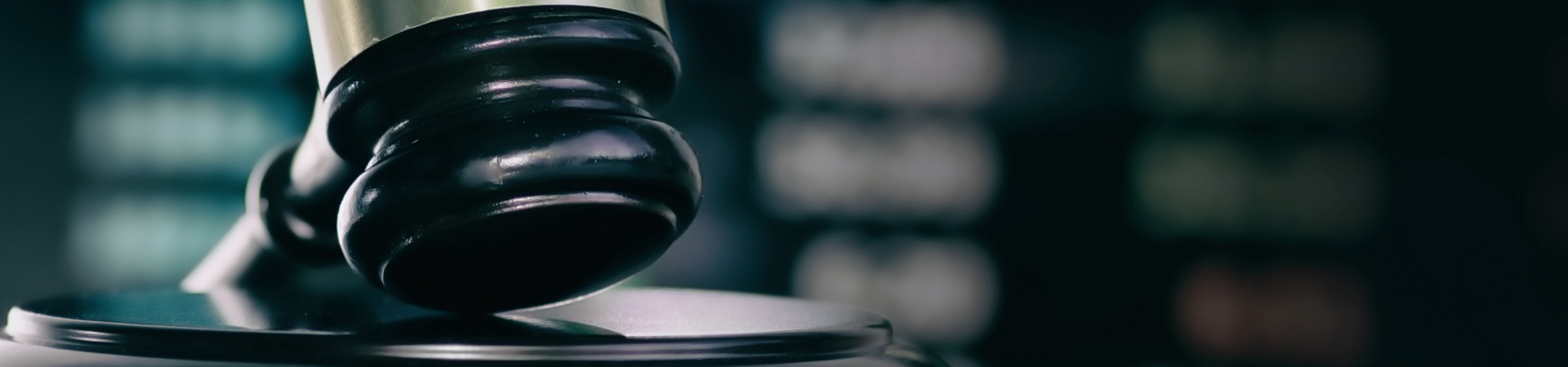 Judges gavel with glowing computer screen monitor background.