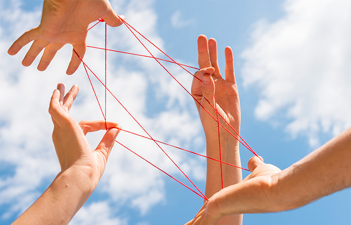 Hands in the sky holding a wire